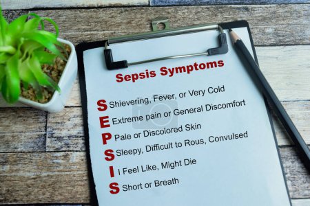 Concept of Sepsis Symptoms write on paperwork with keywords isolated on wooden background.