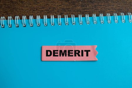 Concept of Demerit write on sticky notes isolated on Wooden Table.