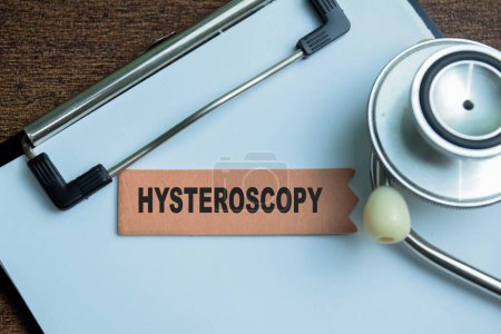 Concept of Hysteroscopy write on sticky notes with stethoscope isolated on Wooden Table.