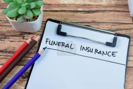 Concept of Funeral Insurance write on paperwork isolated on wooden background.
