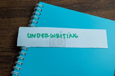 Concept of Underwriting write on sticky notes isolated on Wooden Table.