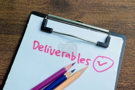 Concept of Deliverables write on paperwork isolated on wooden background.