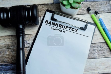 Concept of Bankruptcy Chapter 13 write on paperwork isolated on wooden background.