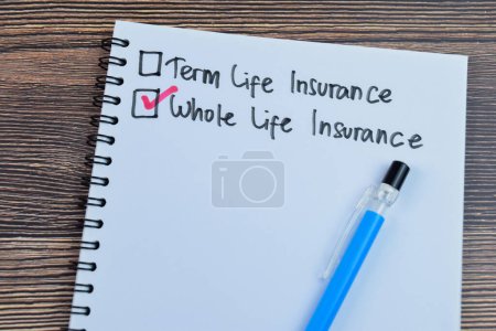 Concept of Whole Life Insurance write on book isolated on Wooden Table.