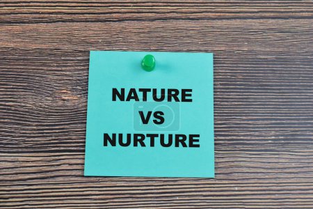 Concept of Nature vs Nurture write on sticky notes isolated on Wooden Table.