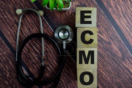 Concept of The wooden Cubes with the word Ecmo on wooden background.