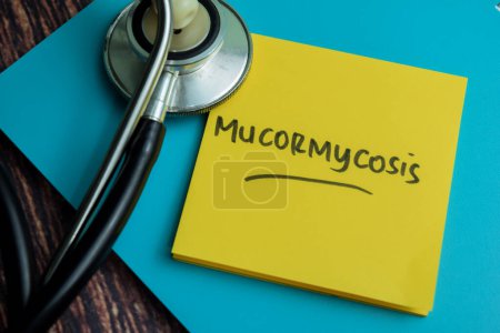 Concept of Mucormycosis write on sticky notes isolated on Wooden Table.
