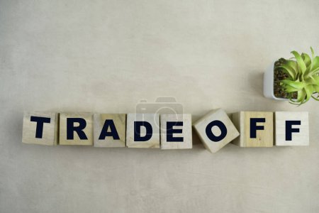 Concept of The wooden Cubes with the word Tradeoff on wooden background.