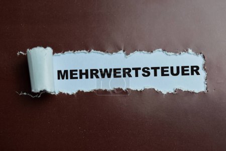 Concept of Mehrwertsteuer Text written in torn paper.
