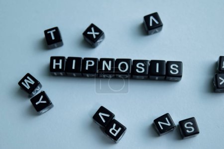 Concept of Hipnosis written on wooden blocks. Cross processed image on Wooden Background