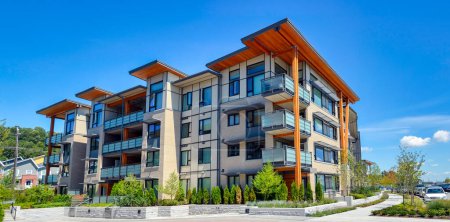 Photo for Brand new apartment building on sunny day in British Columbia, Canada. - Royalty Free Image