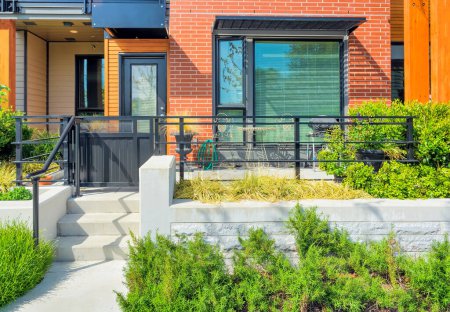 Photo for A perfect neighbourhood. Land terrace and small patio in front of private entrance to a residential unit in British Columbia - Royalty Free Image