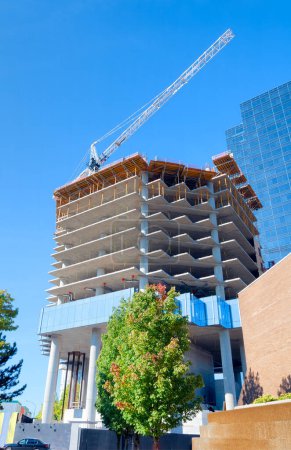 Photo for Concrete high rise building under constraction on blue sky background - Royalty Free Image
