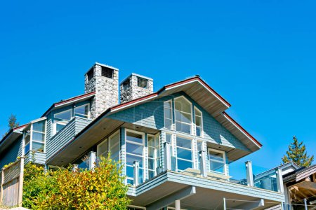 Photo for Top of residential house with patio on blue sky background. - Royalty Free Image