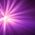 Purple flash light on dark background. Violet glowing light. Sun burst effect. Digital lens flare effect. Abstract purple background.