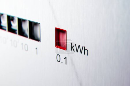 3D rendering of an electrometer measuring electricity consumption with a kWh counter. The electric meter display changes numbers, symbolizing the concept of rising costs of electric power.
