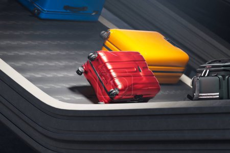 Photo for One dirty, red, worn, destroyed suitcase is forever lost in luggage limbo hell. An unlucky customer still waiting for his stuff. The slippery conveyor belt fails to lift the package. - Royalty Free Image