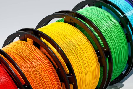 Photo for A close-up of different colored thermoplastic filament spools used for 3D printing. These filaments, made of materials such as PLA, ABS, and PET-G, are essential for creating 3D prints - Royalty Free Image