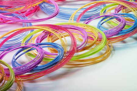 Photo for Vibrant, multicoloured thermoplastic filaments for use in 3D printers. Add a splash of colour to your 3D printing projects with these high-quality filaments. - Royalty Free Image