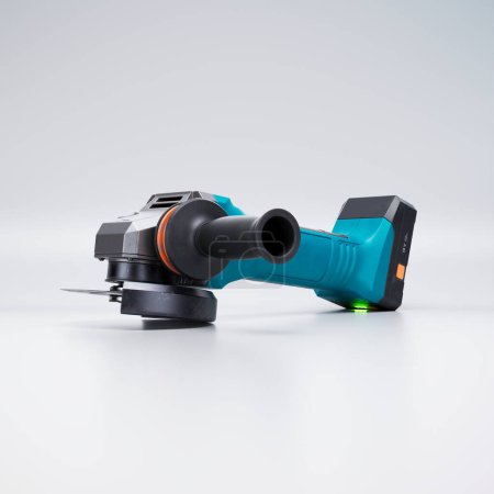 This 3D rendering image features a brand new angle grinder in a modern design with turquoise and orange details. Perfect for renovation and repair projects to construction work.