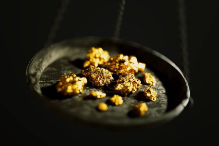 Photo for Close up of a jewellery scale with gold nuggets. Weighting gold ores on an old brass scale dish for trade or exchange. Concept of Wealth, treasure, fortune, success, luxury, money - Royalty Free Image