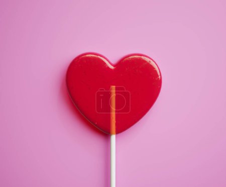 Photo for The red heart-shaped lollipop. Cute tasty sweets on a stick. Symbol of love. Sweet assorted candy on pink background. Delicious romantic Valentine's Day gift. - Royalty Free Image