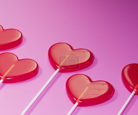 Photo for The red heart-shaped lollipops. Set of cute tasty sweets on sticks. Symbol of love. Sweet assorted candies on pink background. Delicious romantic Valentine's Day gift. - Royalty Free Image
