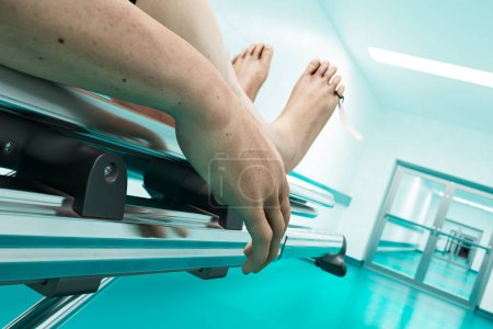 Photo for A dead man on a metal hospital bed on the hallway. Corps on a gurney. Close-up on the hand of the dead person. Concept of death caused by a coronavirus, fatal disease. Infection fatality of COVID-19 - Royalty Free Image
