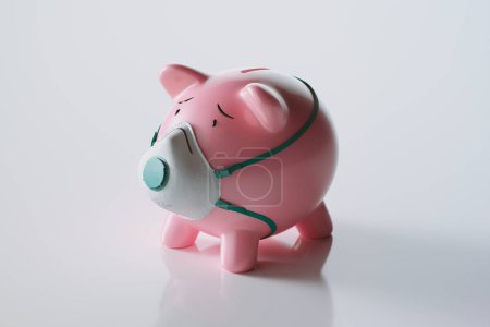 A sad piggy bank warring respiratory protective mask. Concept of health and financial issues while the epidemic of coronavirus. COVID-19 protection. Prevention of infection. Pandemic. Influenza, SARS.