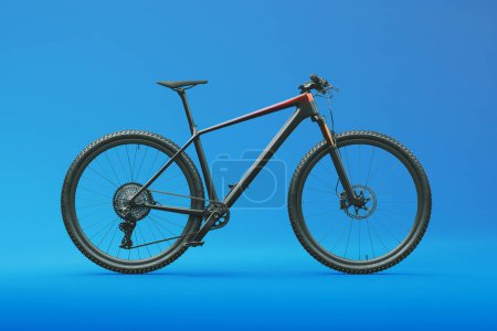 Photo for The image showcases a mountain bike in a studio setting against a blue background. A photoshoot of a bike for use in an online store. Representation of fitness, healthy lifestyle, and sports equipment - Royalty Free Image