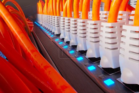 Foto de Muchos cables de red Ethernet naranja en un moderno gabinete de la sala de servidores en una granja de renderizado oscuro iluminado por un solo foco. Cables etéreos coloridos organizados. Primer plano.. - Imagen libre de derechos