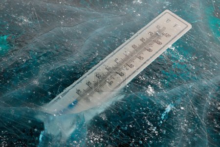 Photo for The thermometer trapped in the thick ice in winter surrounding. The mercury column showing extremely low temperature. Freezing cold. Wheater measurements. Wintertime. It's cold outside. Snowy season. - Royalty Free Image