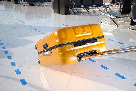 Photo for A POV view of dragging a bright yellow suitcase on wheels on a clean white airport floor. Going between terminals in a rush. The shot is taken from the perspective of the person carrying the suitcase - Royalty Free Image