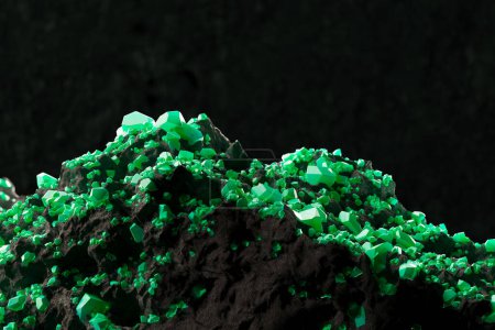 Green uranium ore gems with rocks and minerals in a mine. Highly concentrated energy source and extremely deadly atomic weapon fuel. The glowing green ore contrasts with the dark and damp environment