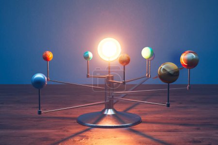 Foto de Modelo de sistema Solar de juguete de pie sobre un escritorio en una habitación. Los ocho planetas en los brazos giratorios giran alrededor de la bombilla brillante que imita al Sol. Perfecto para fines educativos. - Imagen libre de derechos