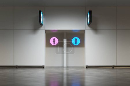 Téléchargez les photos : L'entrée de toilettes publiques dans un aéroport ou une gare. Les signes lumineux sur le mur indiquent le sexe des toilettes. Le signe est très lumineux et peut être facilement vu à distance. WC - en image libre de droit