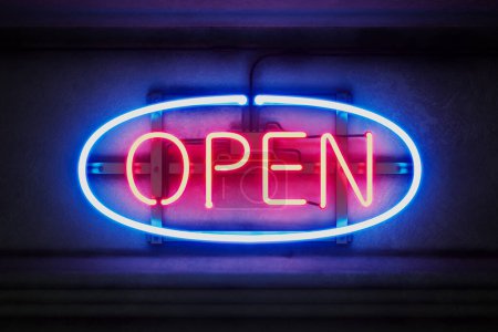 Photo for Night view at a shining open neon sign glowing in the dark. A store, restaurant, pub, cafe, casino, bar, hotel, or even gas station is opened. Red-blue banner illumination glowing in evening scenery. - Royalty Free Image
