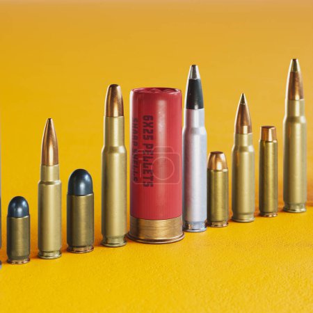 A huge row of different bullet types standing on the concrete floor. Huge variety of ammunition calibers. Handgun, carabine, automatic, shotgun, and more. Deadly combat force. Yellow background