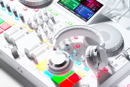Téléchargez les photos : DJ set avec écouteurs Deejay professionnels dans une atmosphère de studio blanc lunatique avec des lumières colorées illuminant le matériel contemporain. Pièce moderne de technologie de divertissement de musique - en image libre de droit