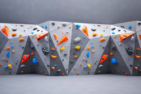 A picture of the climbing or bouldering wall. Rock extreme sport activity for indoor training and exercise in leisure time. Test your skills as you navigate through a variety of routes and obstacles.