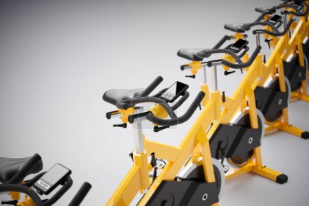Foto de Una fila de bicicletas de entrenamiento amarillas ordenadas cuidadosamente en una línea. Un gimnasio moderno o un gimnasio. Una intensa sesión de entrenamiento cardiovascular y fitness. Salud, bienestar, cardio, concepto deportivo. - Imagen libre de derechos