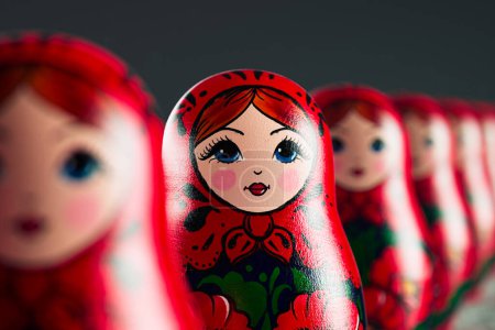 Photo for Beautiful handmade matryoshka dolls in a row. An infinite number of babushkas placed one after another. Set of traditional wooden Russian toys. Art souvenirs painted with colorful ornaments - Royalty Free Image