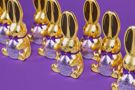 Photo for Set of adorable chocolate Easter bunnies. A row of cute and delicious sweet rabbits on a purple background. Happy Easter. Made with the finest milk and dark chocolate. Joy. Fun. Sweets. Tradition. - Royalty Free Image