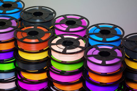 Photo for Multicolored 3D printer filament spools, neatly arranged. It highlights the wide array of options available in the world of 3D printing, emphasizing the limitless potential of this technology. - Royalty Free Image