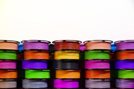 Photo for Multicolored 3D printer filament spools, neatly arranged. It highlights the wide array of options available in the world of 3D printing, emphasizing the limitless potential of this technology. - Royalty Free Image