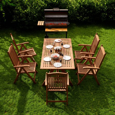 Téléchargez les photos : Un espace repas extérieur accueillant orné de meubles en bois et d'un barbecue moderne, niché dans un jardin luxuriant avec une haie soignée. - en image libre de droit