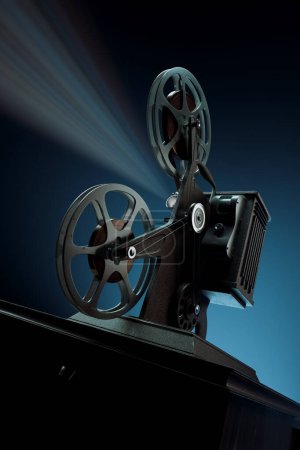 Photo for An evocative scene of an old-fashioned film projector, its bright light piercing the dark background, capturing the essence of bygone cinematic times and the charm of analog technology. - Royalty Free Image
