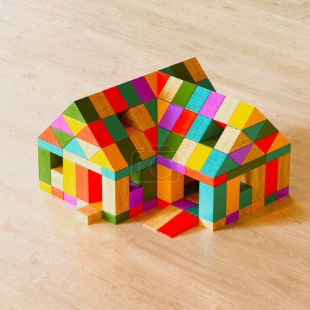 Téléchargez les photos : Une présentation accrocheuse d'une structure en forme de maison créée à partir de blocs de jouets en bois colorés assemblés soigneusement sur une surface en bois, illustrant un jeu éducatif. - en image libre de droit