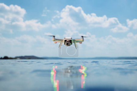 Photo for Capturing the serenity of nature, this drone hovers effortlessly over glassy water, reflecting the vast expanse of the sky and fluffy white clouds in its surface. - Royalty Free Image