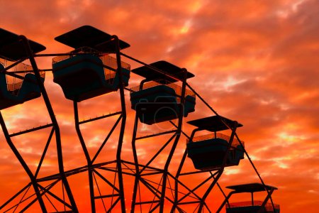 Téléchargez les photos : Capturant l'essence du plaisir et de la fantaisie, cette image met en valeur la silhouette d'une grande roue Ferris face à un ciel couchant captivant et aux teintes orange et rouge éclatantes. - en image libre de droit